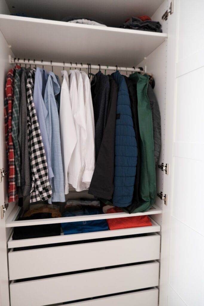a closet full of clothes, neatly organized closet after wardrobe editing service